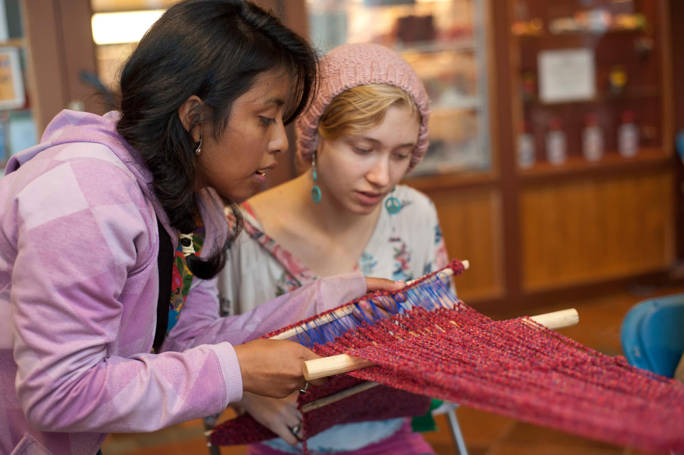 Students participate in a weaving demonstration during PվƵ annual Native American Festival.